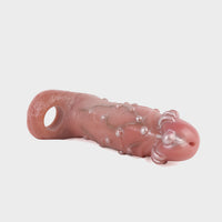 Angled shot displaying the lifelike texture and built-in faux piercings of this cock sleeve.