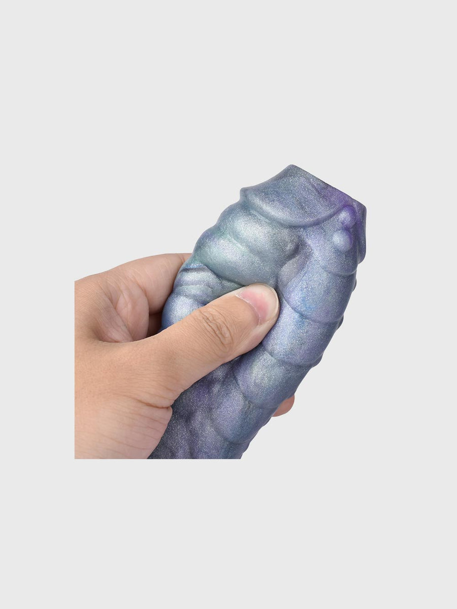 The Ice Dragon Cock Sleeve held in hand, displaying its flexibility and generous length enhancement.
